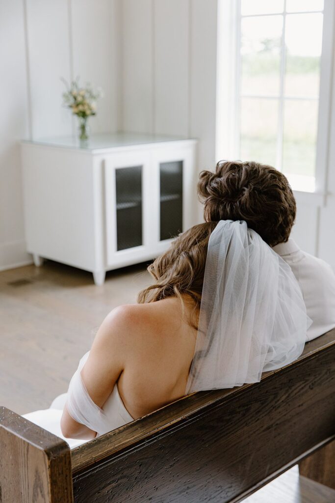 Bride resting head on groom's shoulder