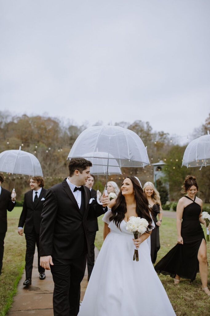 Bride and groom under umbrella at wedding
