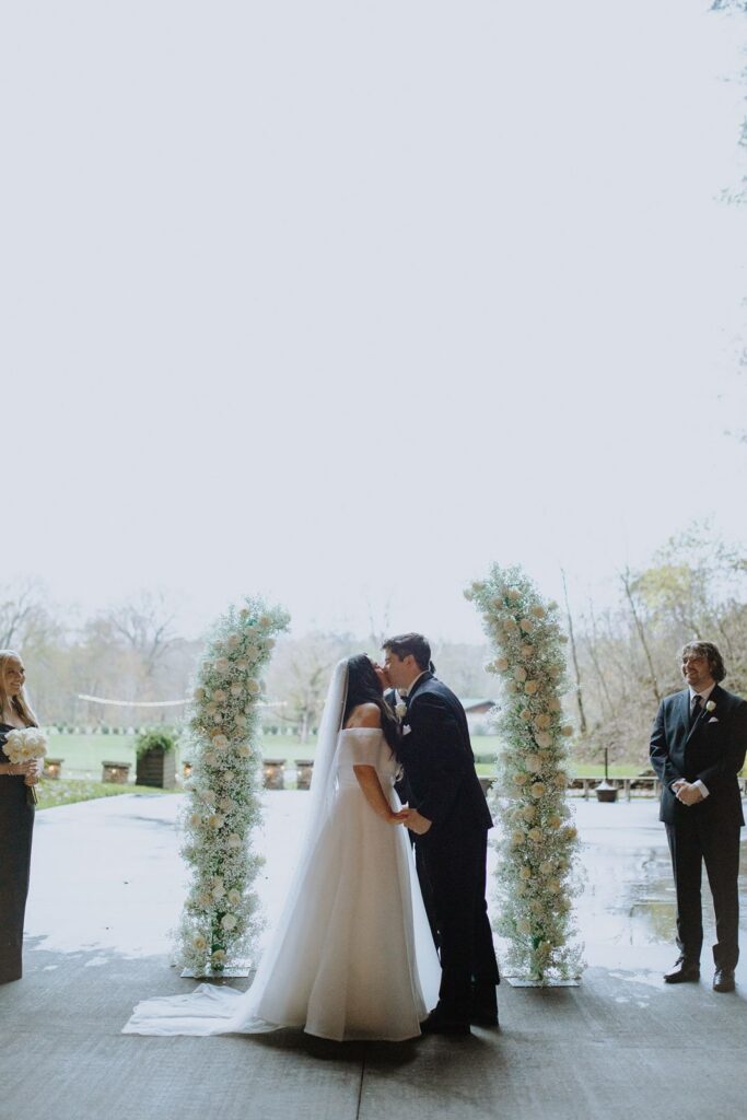 Bride and groom kissing at wedding ceremony