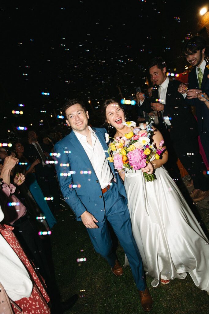 Bride and groom smiling during grand exit