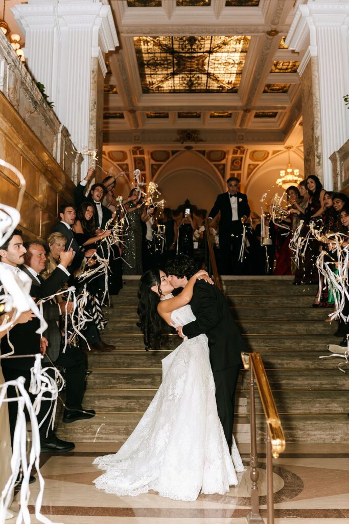 Wedding grand exit bride and groom kiss