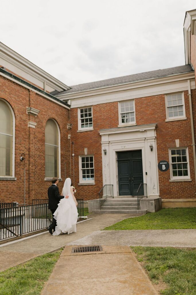 Bride and groom walking into building in Nashville, TN