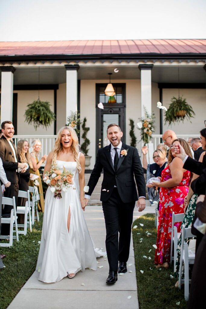Bride and groom leaving outdoor ceremony
