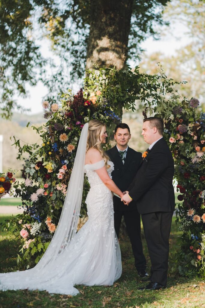 Bride and groom holding hands during ceremony