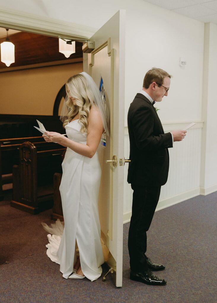 Bride and groom reading wedding vows before ceremony