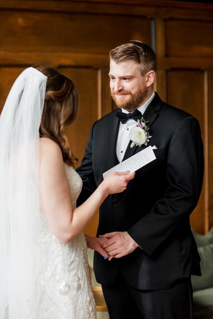 Bride reading wedding vows to groom