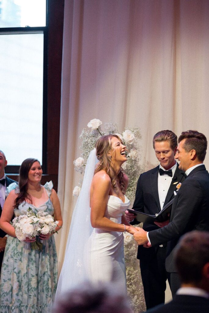 Bride laughing during wedding ceremony