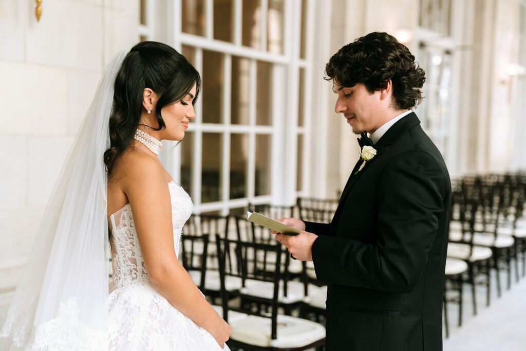 Groom reading wedding vows to bride before ceremony