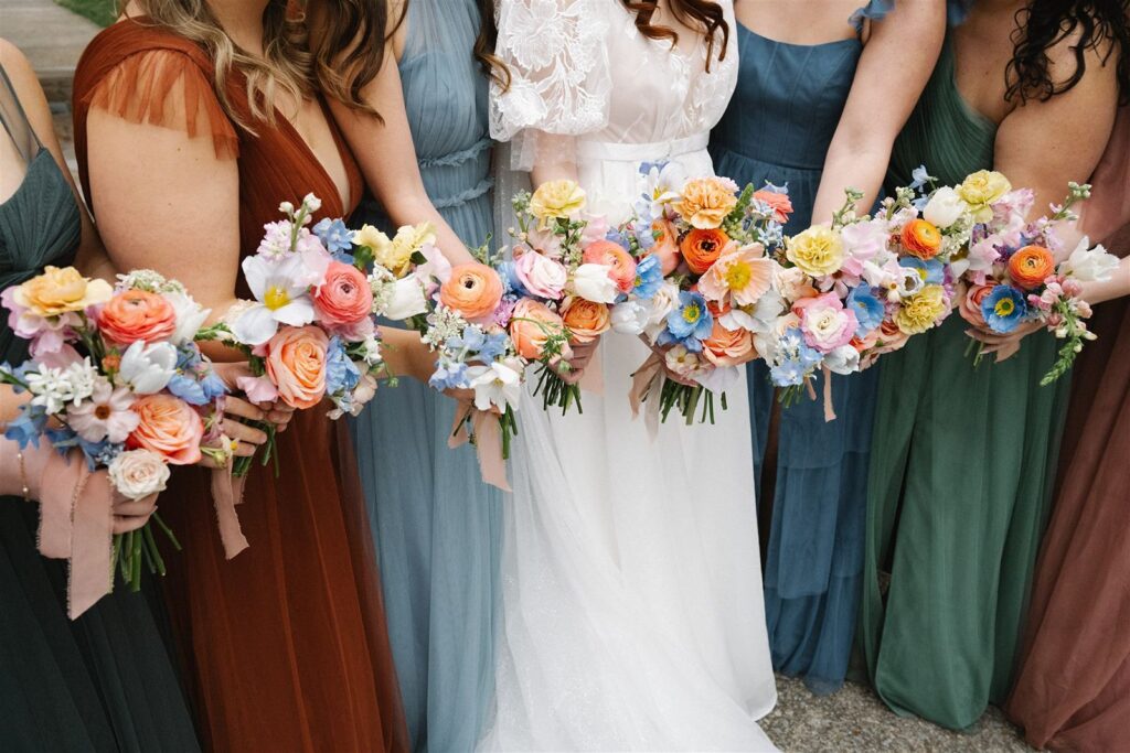 Bride with her bridesmaids holding bouquets