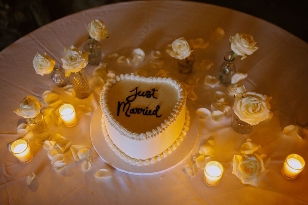 Wedding design cake with candle and floral centerpieces. 