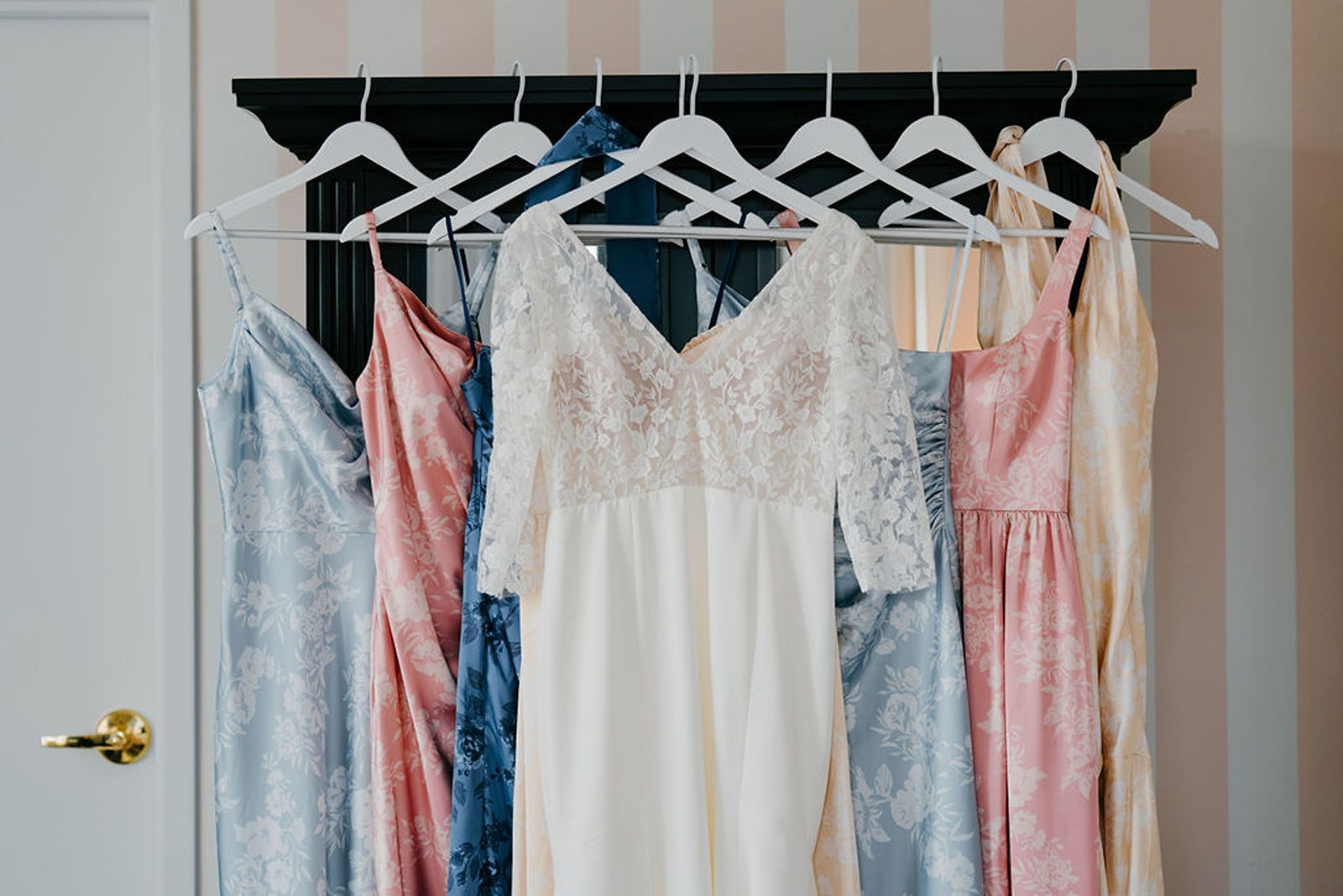 Wedding dress and bridesmaids' dresses handing together