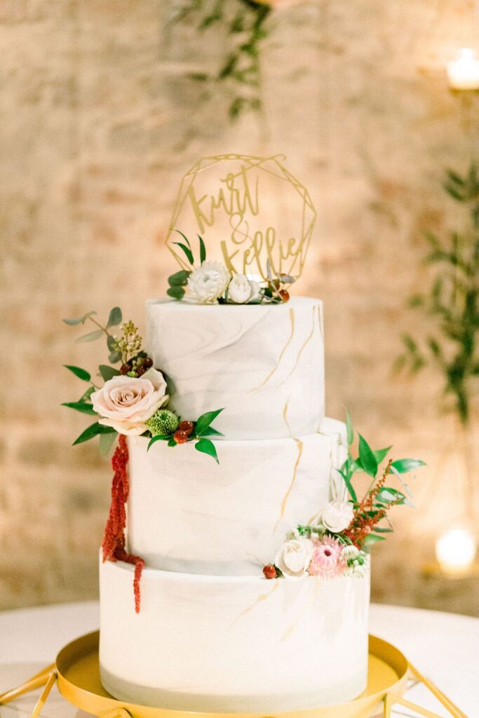 three-tier wedding cake with cake topper