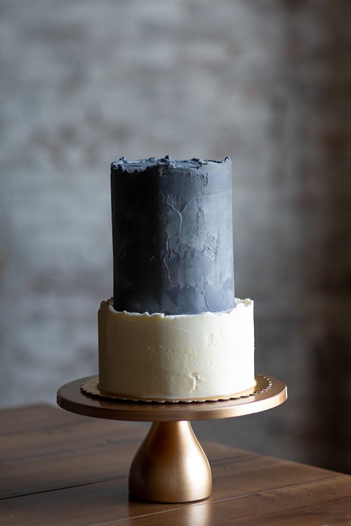 two-tier wedding cake on gold stand