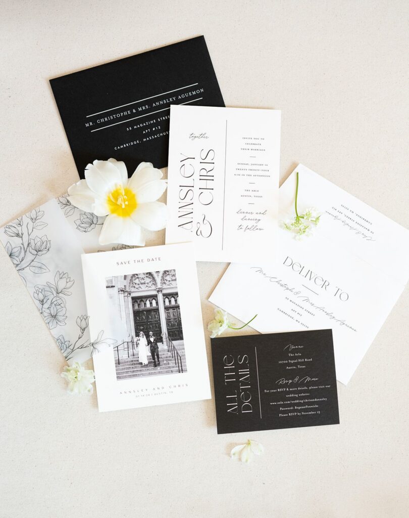 Wedding invitation suite laid out on table