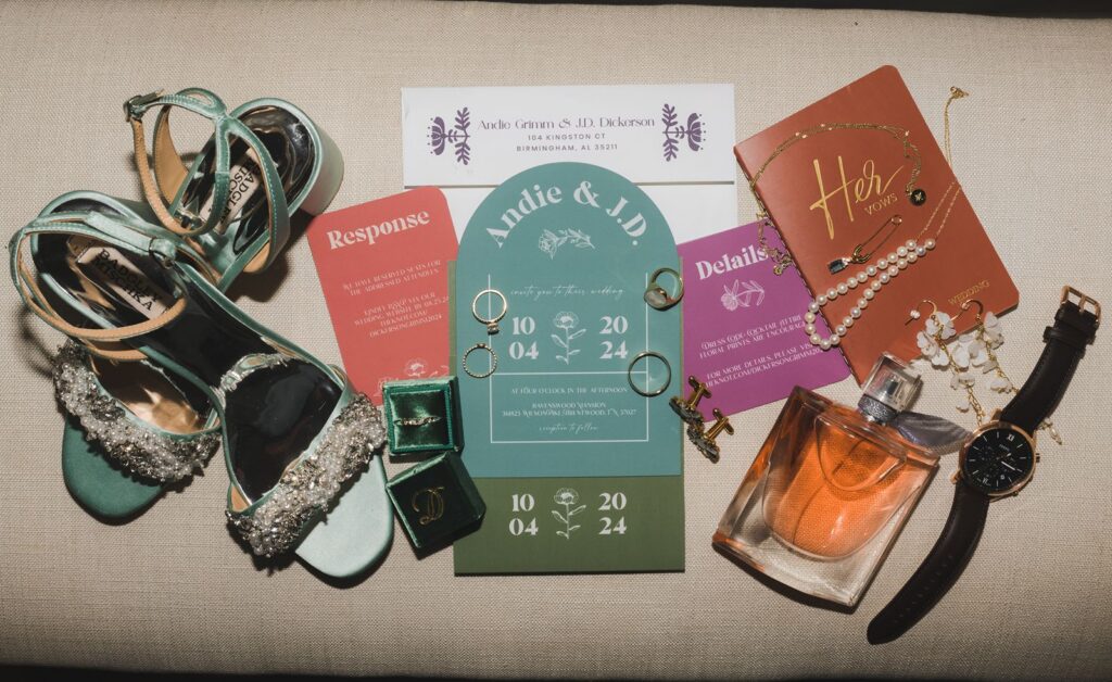 Guide to wedding invitation suite laid out with shoes, watch, and rings