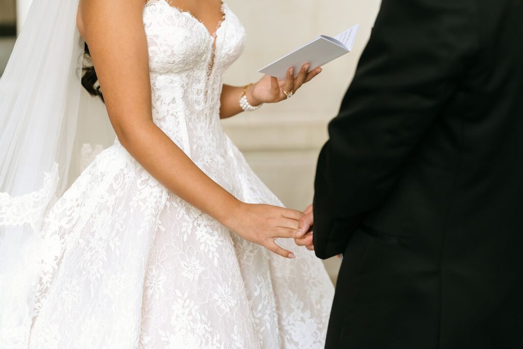 Bride and groom holding hands while reading letters