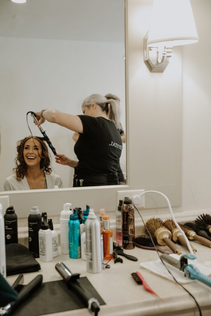 Bride getting her hair done before wedding
