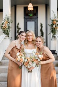 bride standing with bridesmaids who are wearing mocha mousse dresses