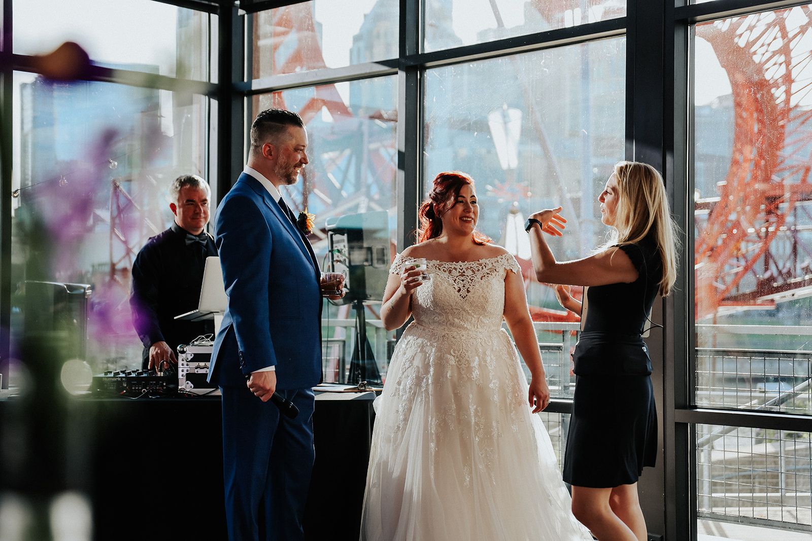 a wedding planner talking to a bride and groom at their reception