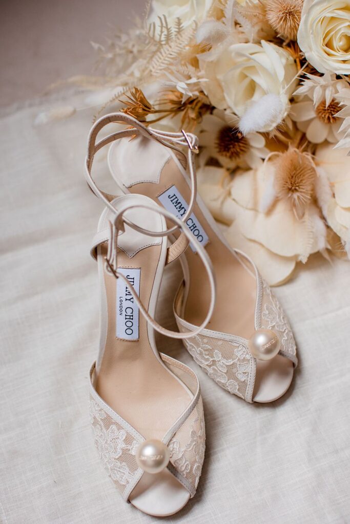 bride's shoes and bouquet at a cannery hall wedding