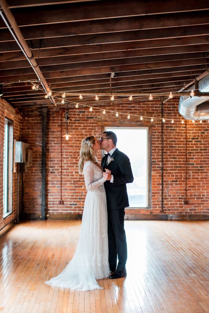 bride and groom share a kiss at cannery hall wedding in amaranth