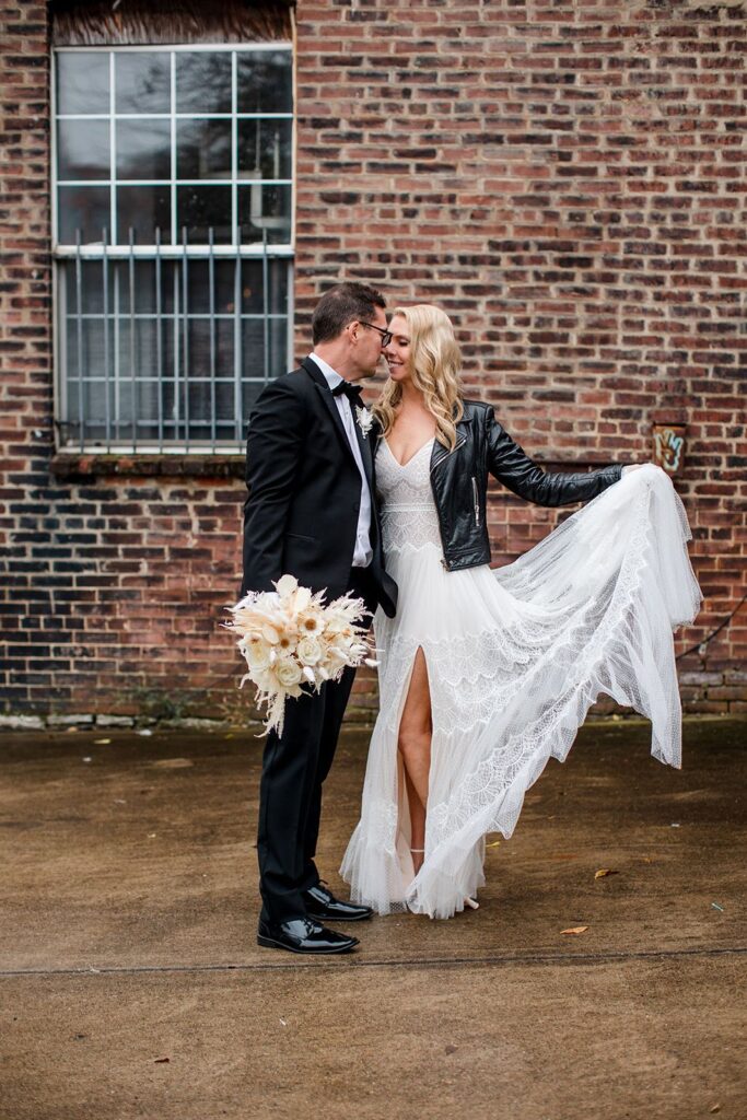 bride and groom pose outside of a cannery hall wedding