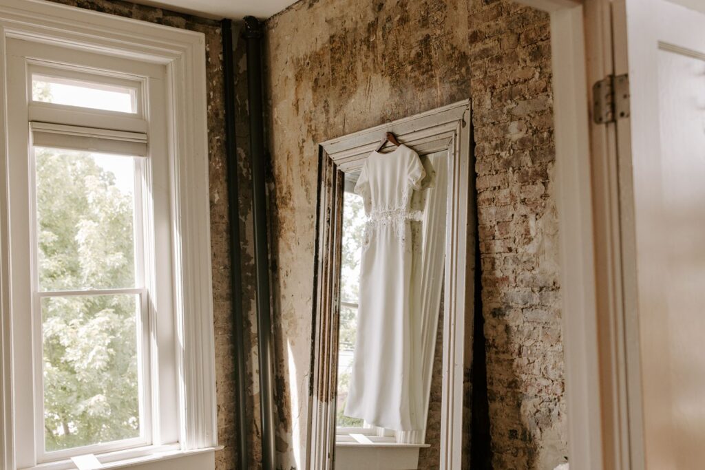 wedding gown hanging on a mirror