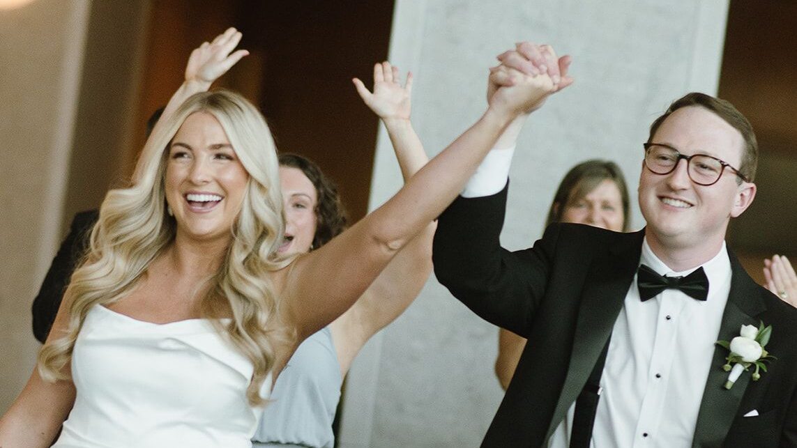 Bride and groom holding hands celebrating in Nashville, TN