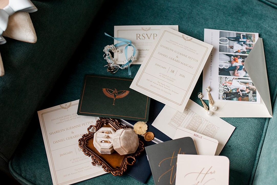 Wedding invitation laid out on green chair